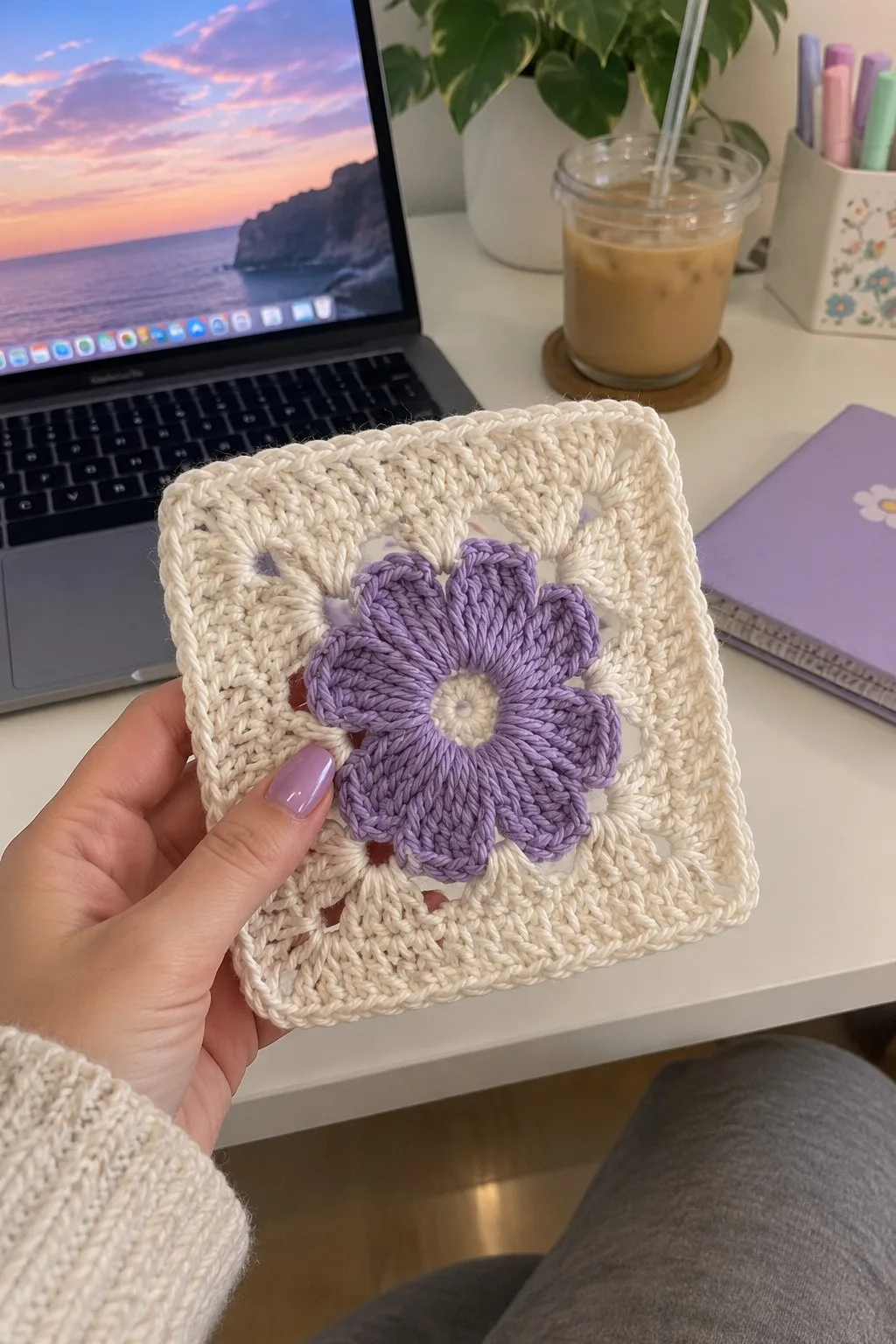 Cream and lavender granny square with raised purple flower center and lacy cream square border